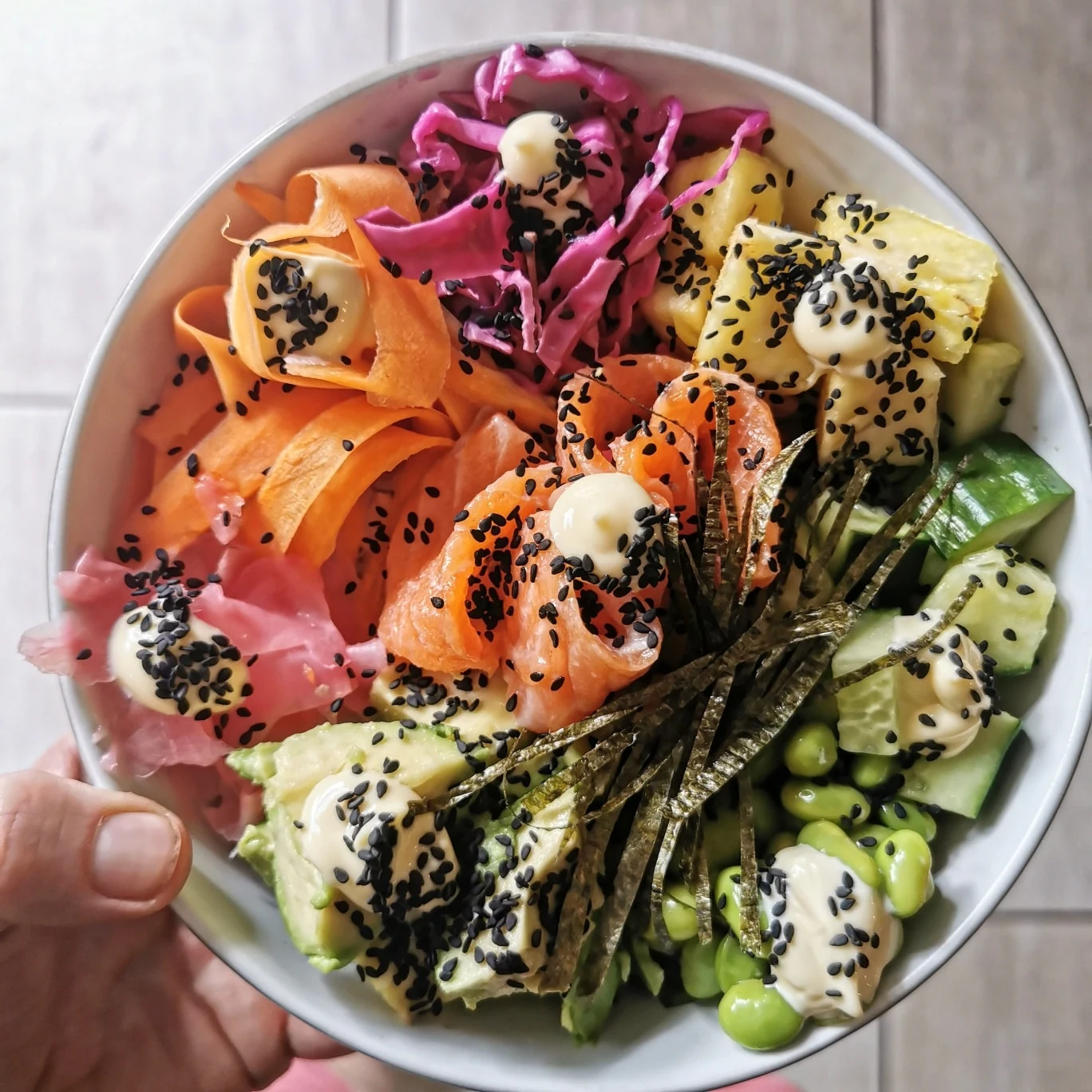 A poke bowl with pickled vegetables, edamame and sesame