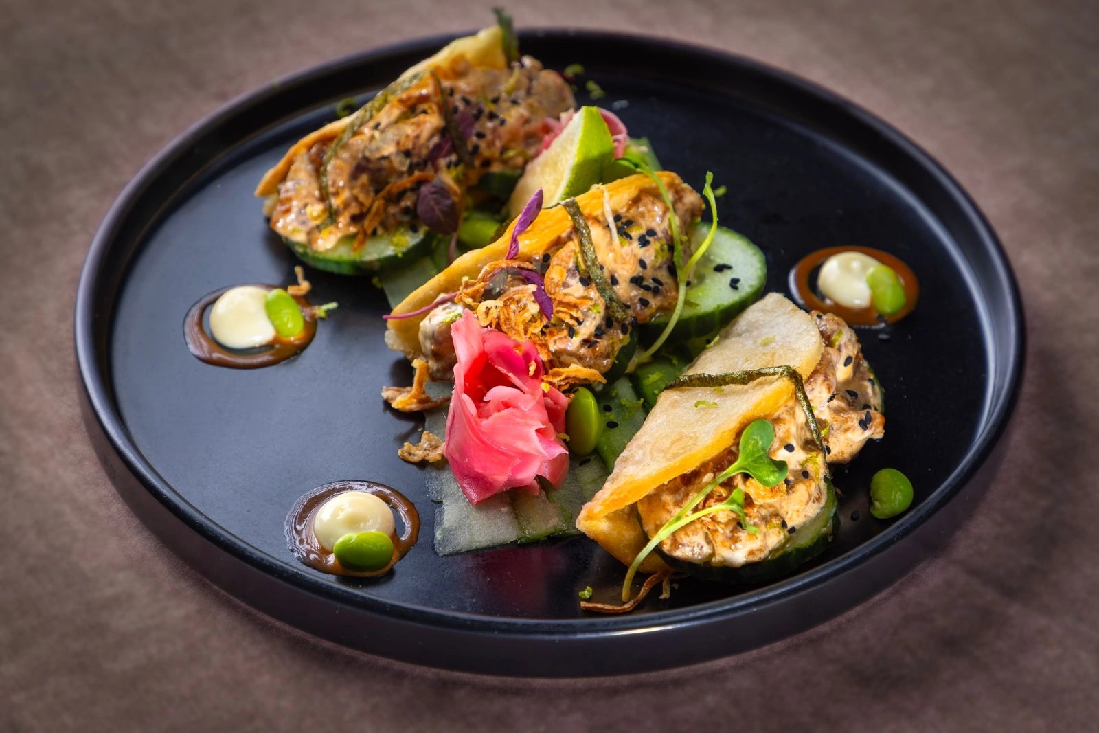 Crispy fried sushi tacos with pickled ginger, edamame and cucumber
