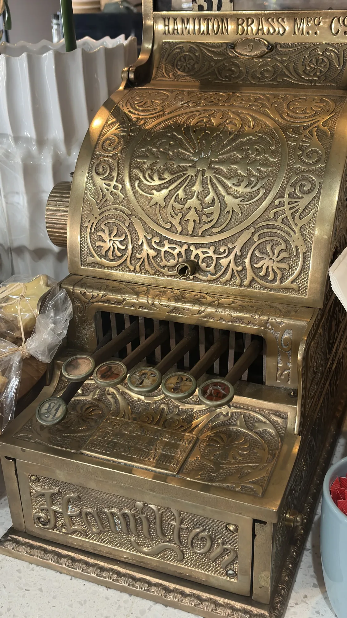 The old brass Hamilton till on the counter