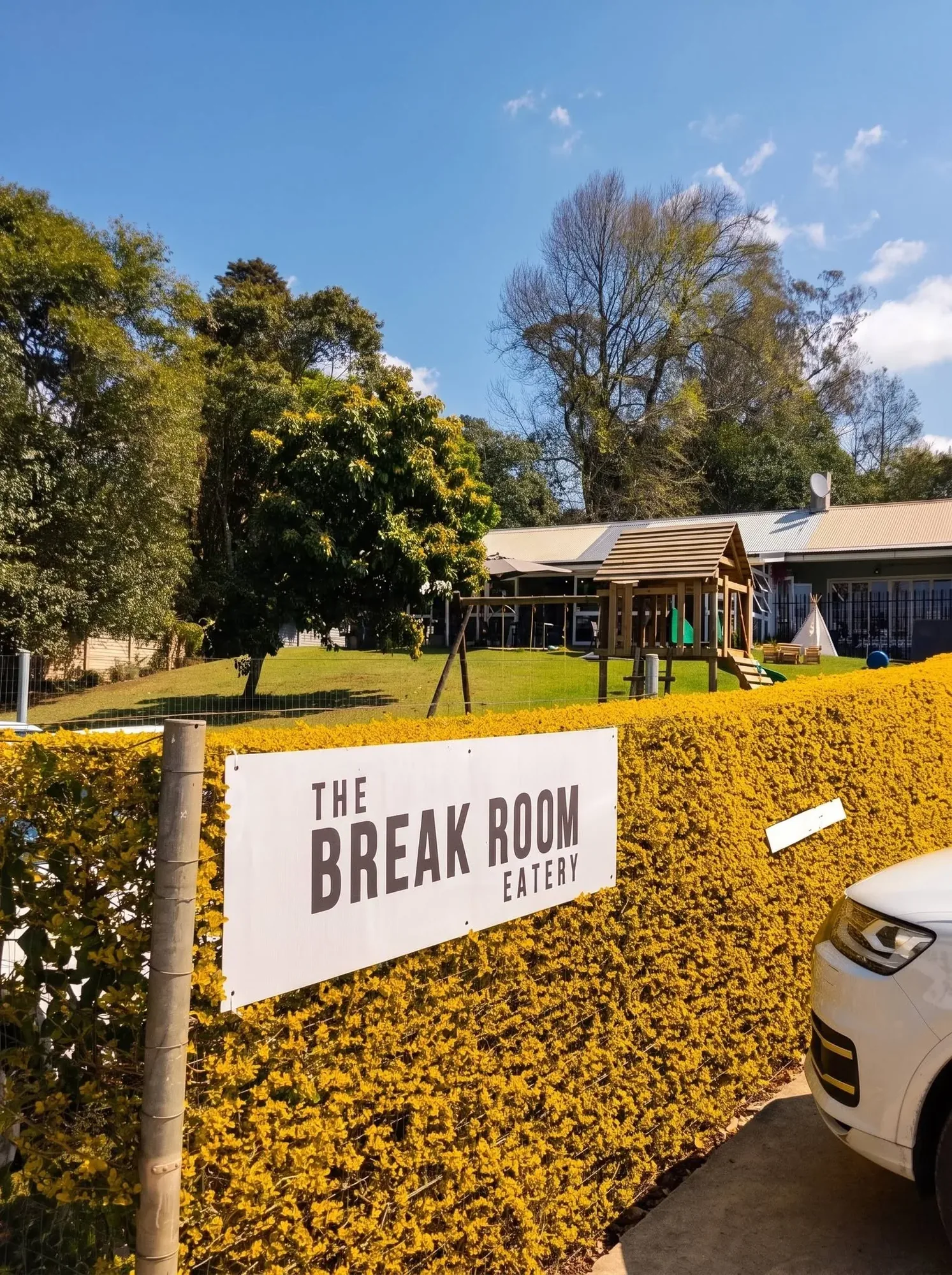 The Break Room sign on the hedge at the entrance