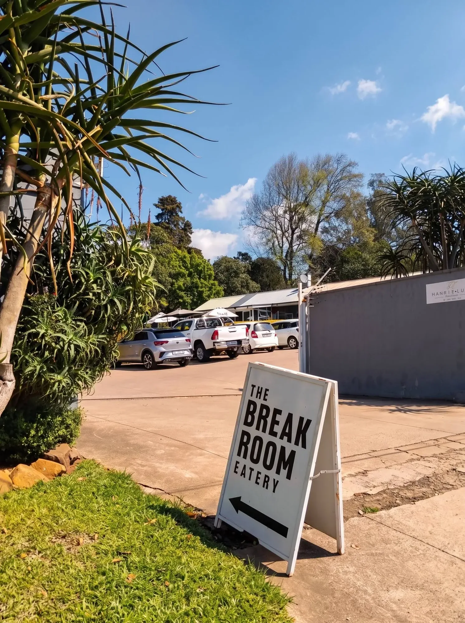 The Break Room pavement sign pointing to the parking